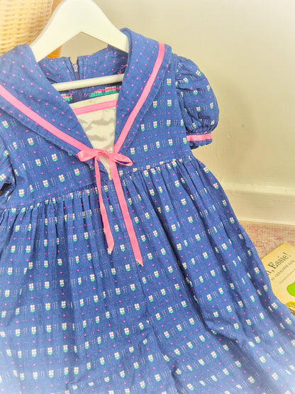 2-3 years. Blue vintage romper with pink satin ribbon and floral details