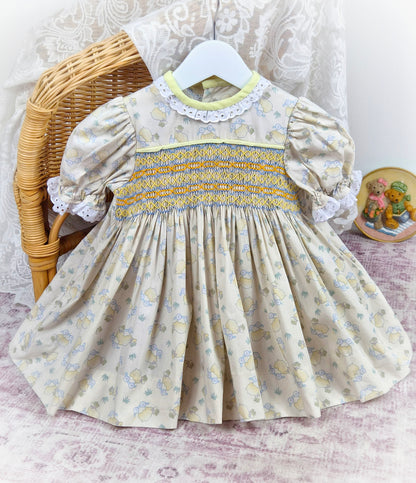 18-24 months. Beige vintage smock dress with toy sheep print, puff sleeves and coloured embroidery