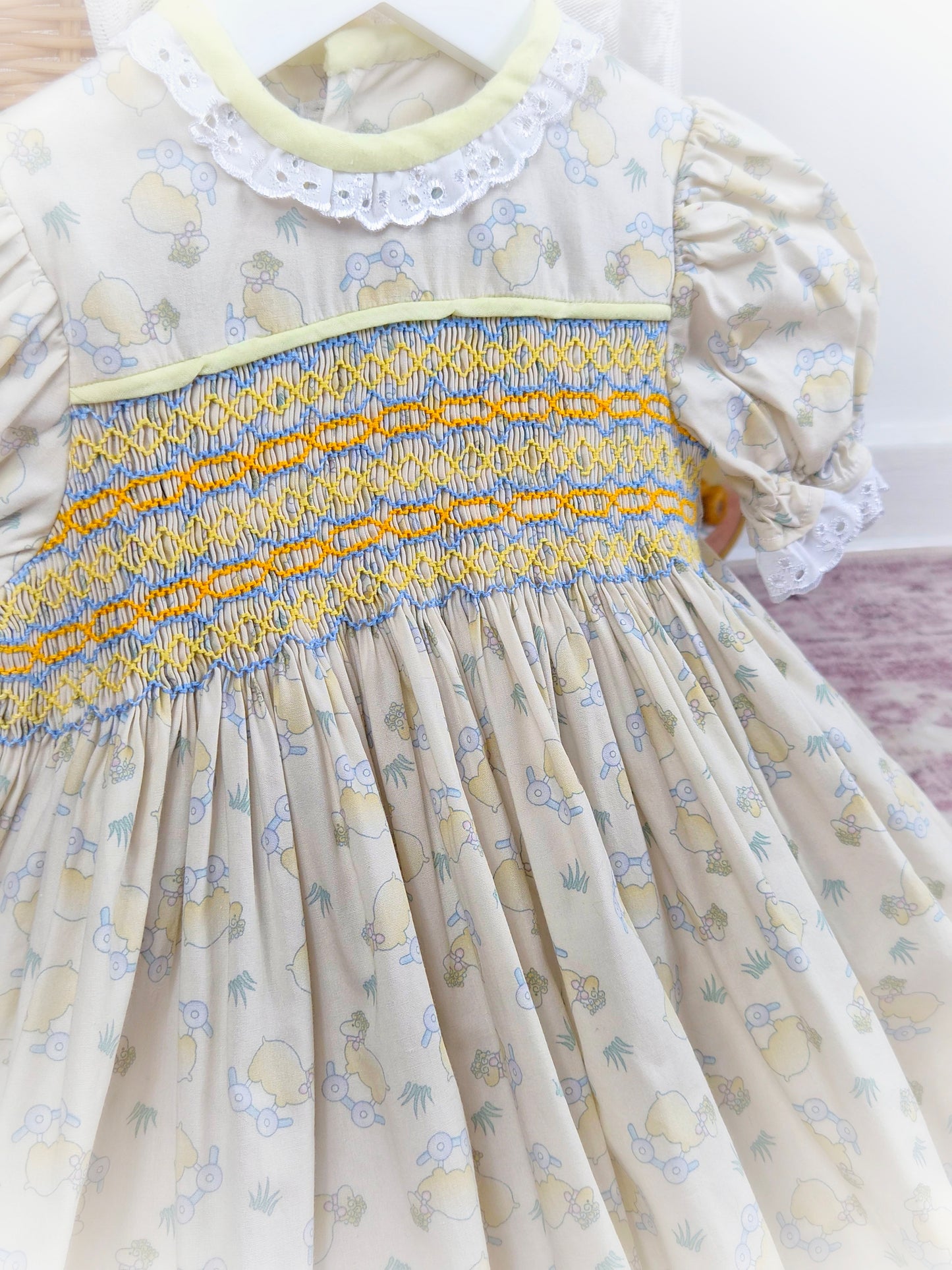 18-24 months. Beige vintage smock dress with toy sheep print, puff sleeves and coloured embroidery