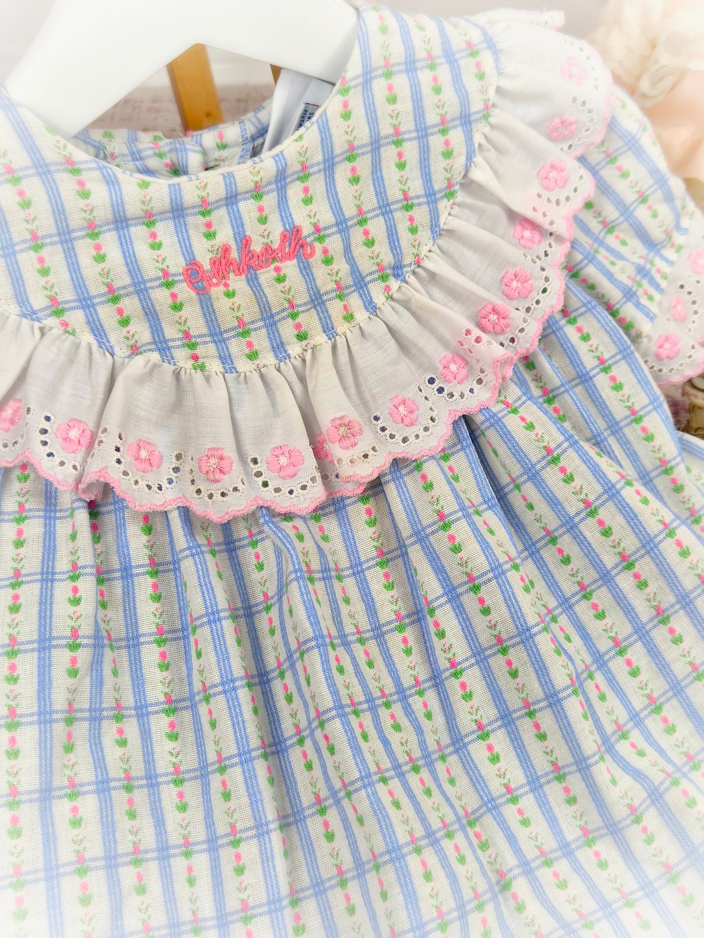 12-18 months. Blue checked Oshkosh dress with white frills, pink embroidered eyelet details and delicate flower print