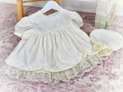 12-18 months. Cream vintage dress with puff sleeves, lace hem and matching hat