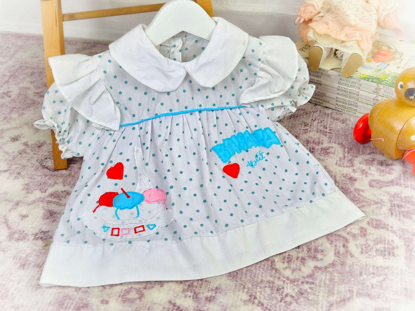 9-12 months. White vintage dress with blue polka dots, white peter pan collar and "banana split"