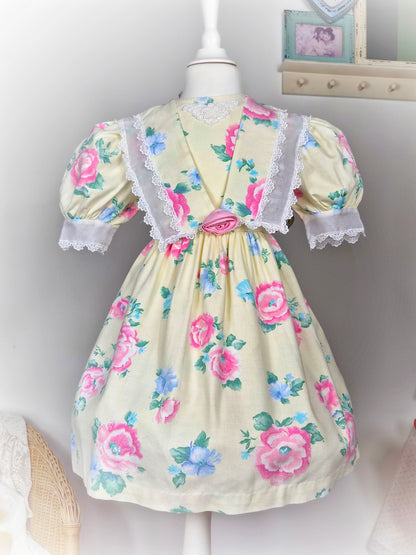 4-5 years. Lemon vintage dress by Atlanta with pink and blue floral print and white lace details