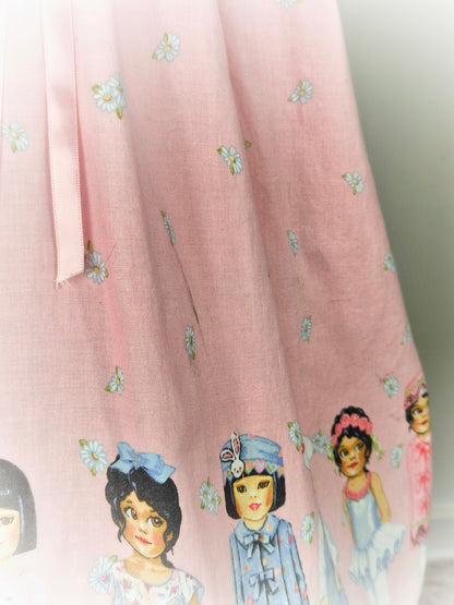 9-10 years. Pink floral vintage dress with multicultural girls, white eyelet bib and pink ribbon. See description*