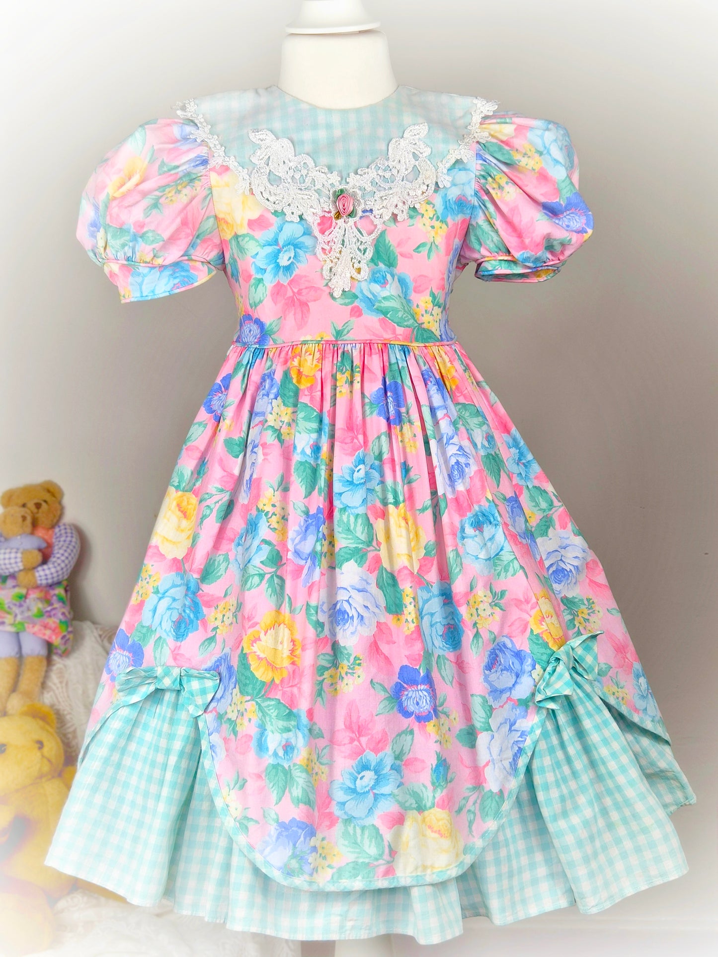5 years. Pink floral vintage dress with mint and white gingham bib, hem and bows, puff sleeves and lace bib