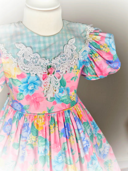 5 years. Pink floral vintage dress with mint and white gingham bib, hem and bows, puff sleeves and lace bib