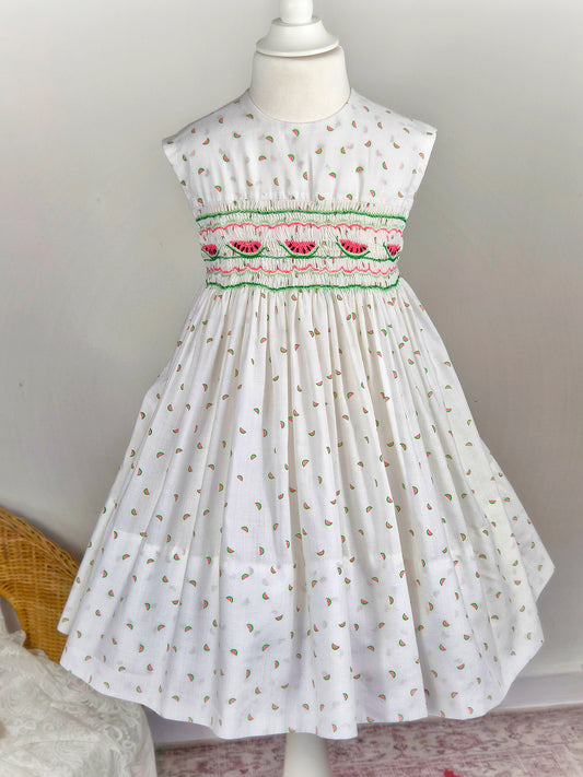 4-5 years. White sleeveless smock dress with embroidered watermelon and print