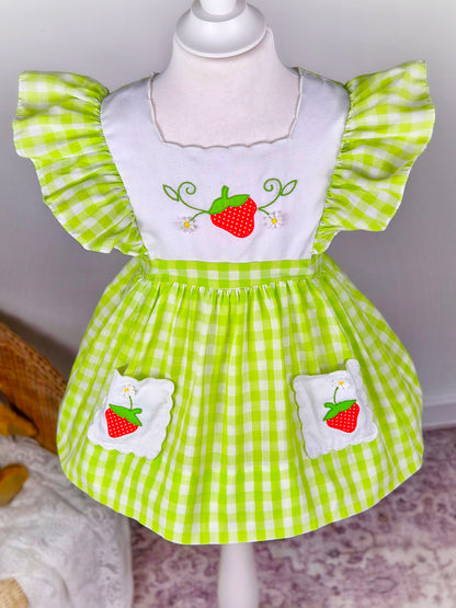 2-3 years. Green and white vintage gingham dress with flutter sleeves, white bib and pockets embroidered with strawberries from Nannette