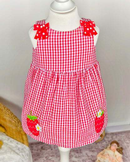 2 years. Red and white sleeveless gingham dress with red polka dot bowsand strawberry appliques