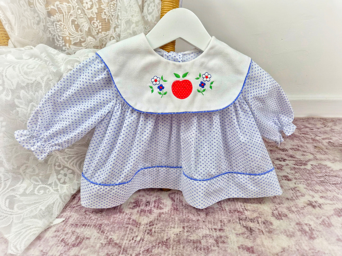0-6 months. White vintage dress with blue patterns and trim, large white bib and embroidered fruit and flowers