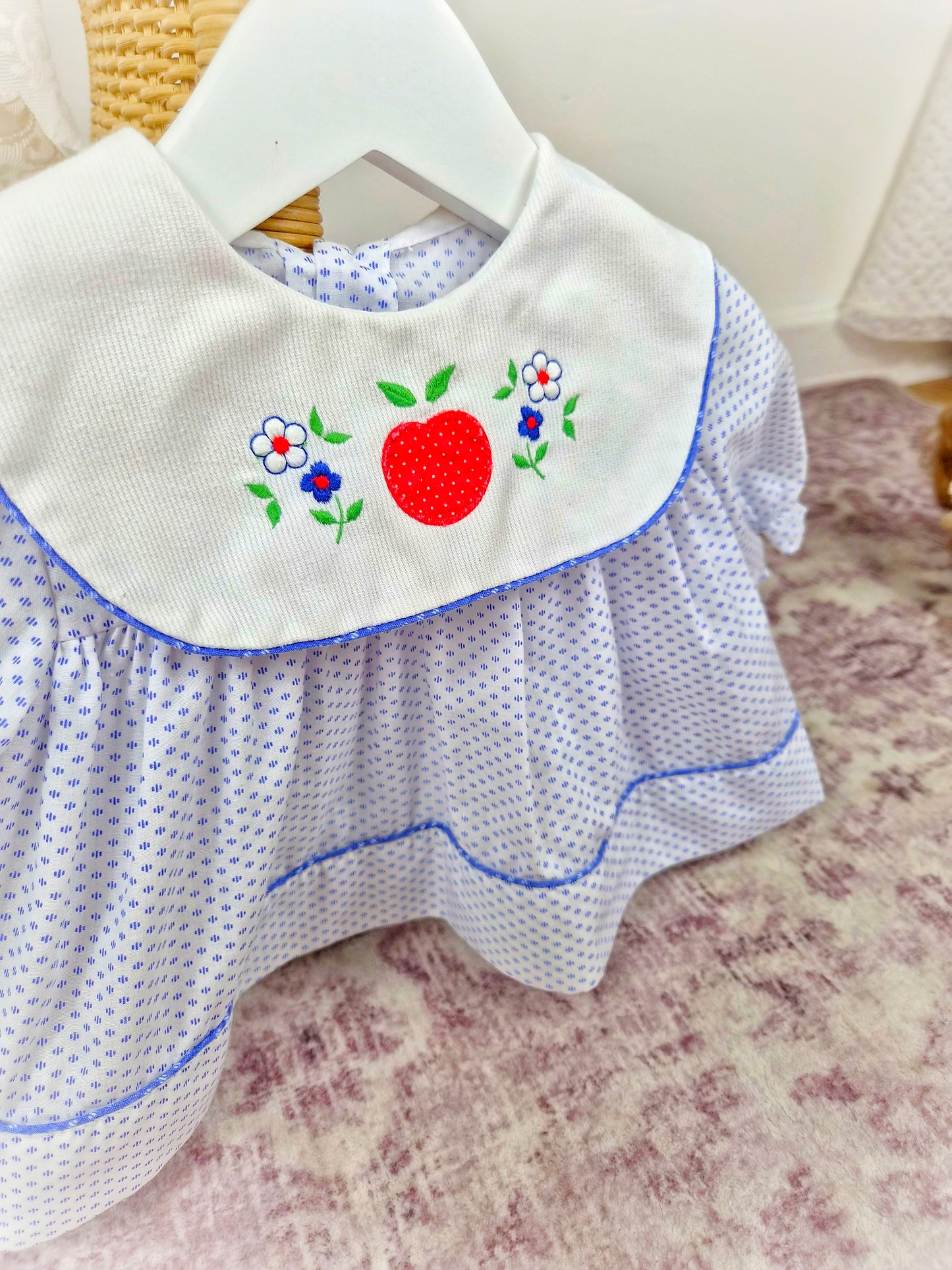 0-6 months. White vintage dress with blue patterns and trim, large white bib and embroidered fruit and flowers