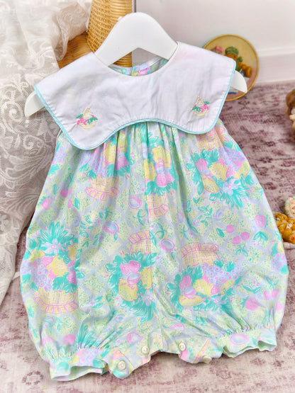 9-12 months. Vintage sleeveless romper by Prenatal with pastel fruit print, white bib and embroidered fruit basket
