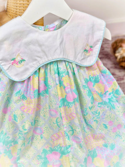 9-12 months. Vintage sleeveless romper by Prenatal with pastel fruit print, white bib and embroidered fruit basket