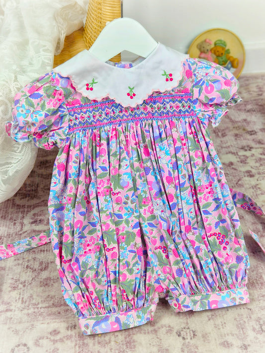 9-12 months. Bright vintage floral smocked romper with white collar and embroidered cherries