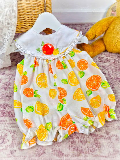 6-9 months. Sleeveless short vintage romper, white with oranges and lemons