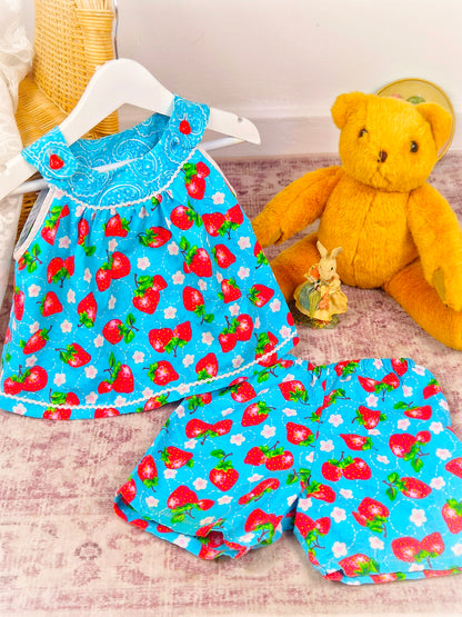 3 years. Two piece set, blue sleeveless top with matching shorts, strawberry print and dainty buttons