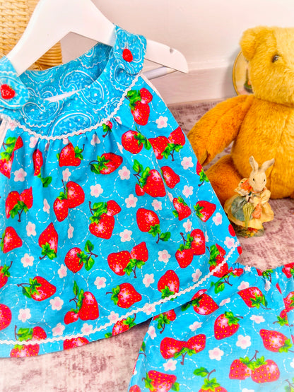 3 years. Two piece set, blue sleeveless top with matching shorts, strawberry print and dainty buttons
