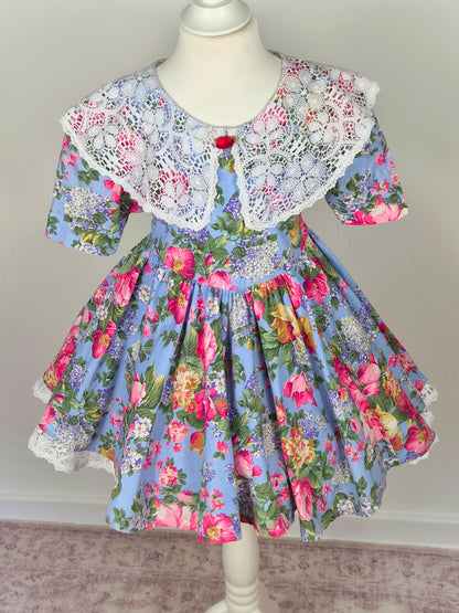 3-4 years. Blue vintage dress with floral design and large white lace bib