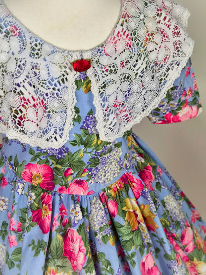 3-4 years. Blue vintage dress with floral design and large white lace bib