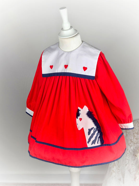 2-3 years. Red vintage Nannette dress with white bib and zebra applique