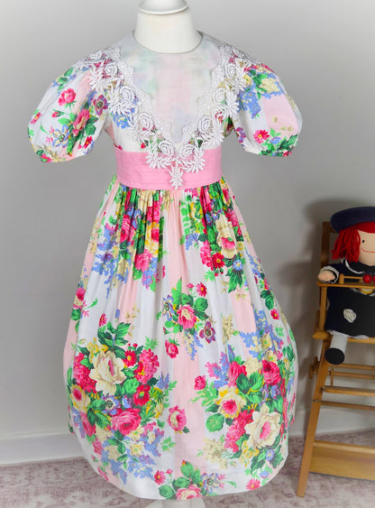7-8 years. Floral vintage Ruth of Carolina dress with large white bib and puff sleeves