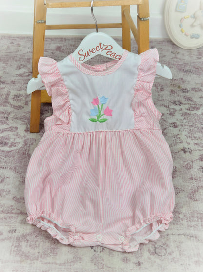 9-12 months. Pink and white striped, sleeveless Alexis romper with frills and embroidered flowers