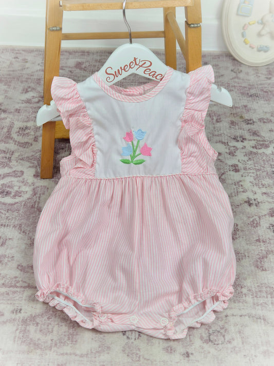 9-12 months. Pink and white striped, sleeveless Alexis romper with frills and embroidered flowers