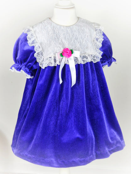 5-6 years. Purple velvet vintage dress from Roget USA with large white lace bib and pink floral centre
