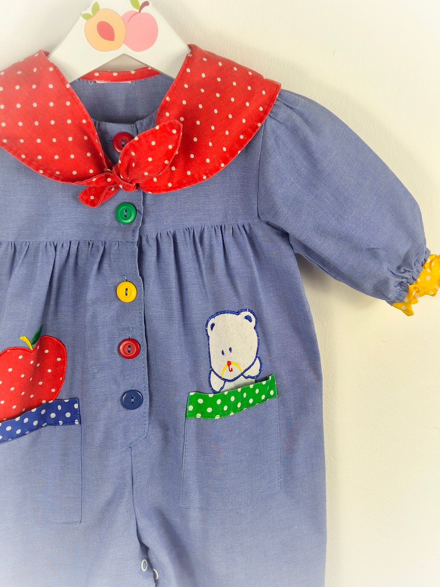12 months. Vintage romper with red polka dot collar, primary coloured buttons & apple and teddy bear appliques