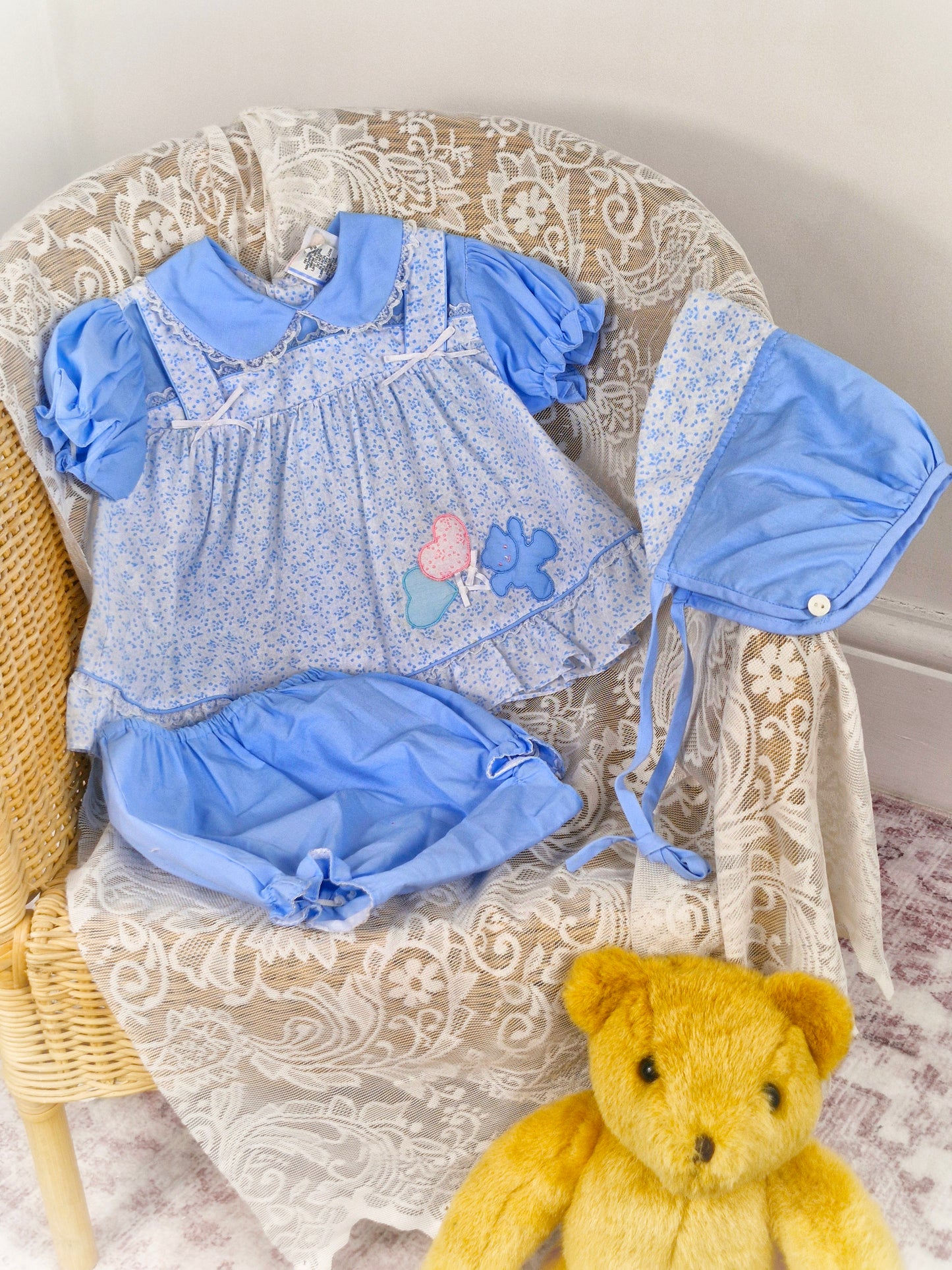 6-12 months. 3 piece vintage Sears set, blue and white floral with teddy applique. Bonnet, dress and bloomers
