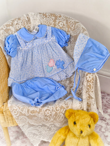 6-12 months. 3 piece vintage Sears set, blue and white floral with teddy applique. Bonnet, dress and bloomers