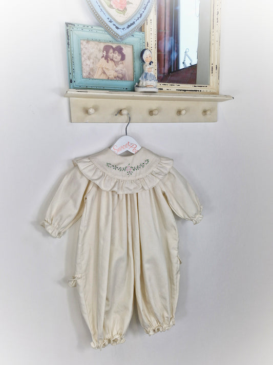 9-12 months Heather Brown romper. Cream with frilly, embroidered bib