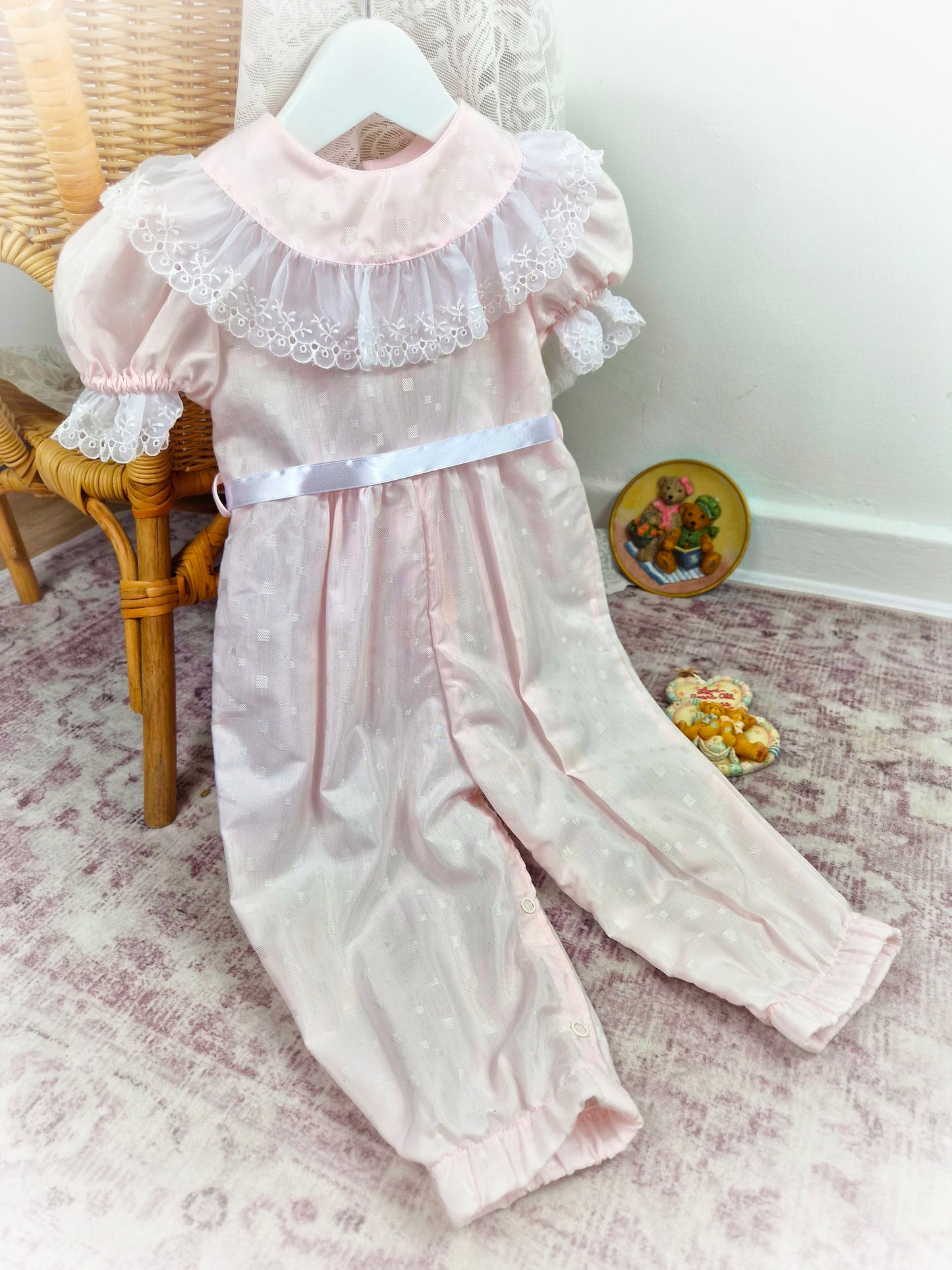 12-18 months. Pale pink vintage romper by I Am Erica with white lace bib trim and satin ribbon