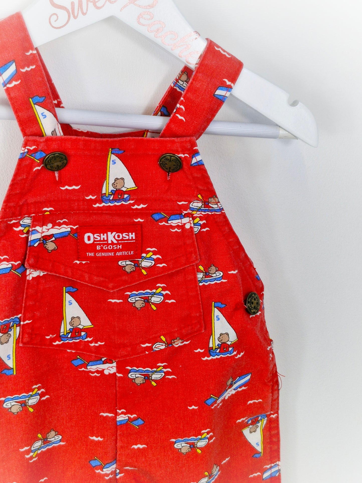 Best fit 6-12 months. Red Oshkosh dungarees with bears
