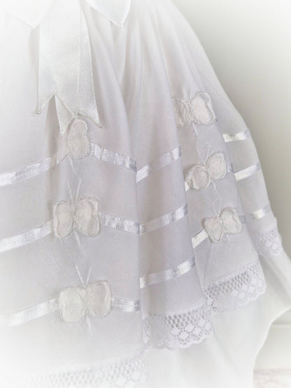 6 years. White dress with ribbon and butterfly details.