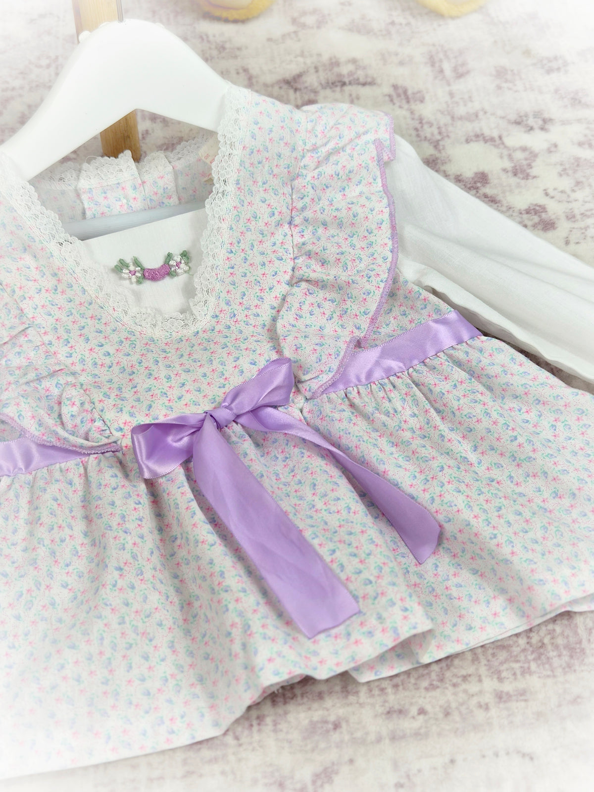 2 years. White vintage long sleeve blouse with lilac ribbon, frills and floral print