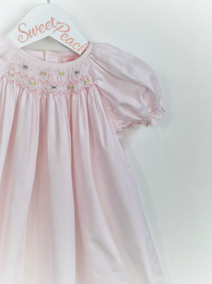 12 months. Petit Ami, pale pink gown with smocking and embroidery neckline
