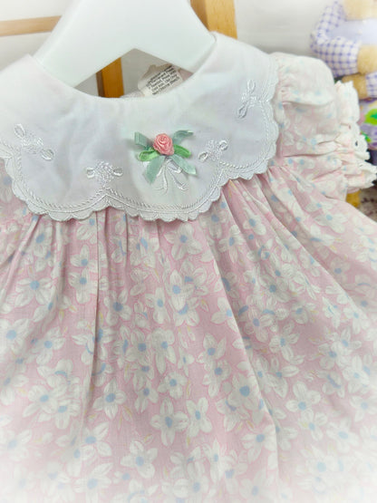 9-12 months. Pink and white floral vintage dress with embroidered details on the bib