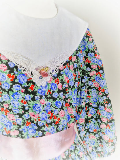 5 years. Black floral dress with white bib