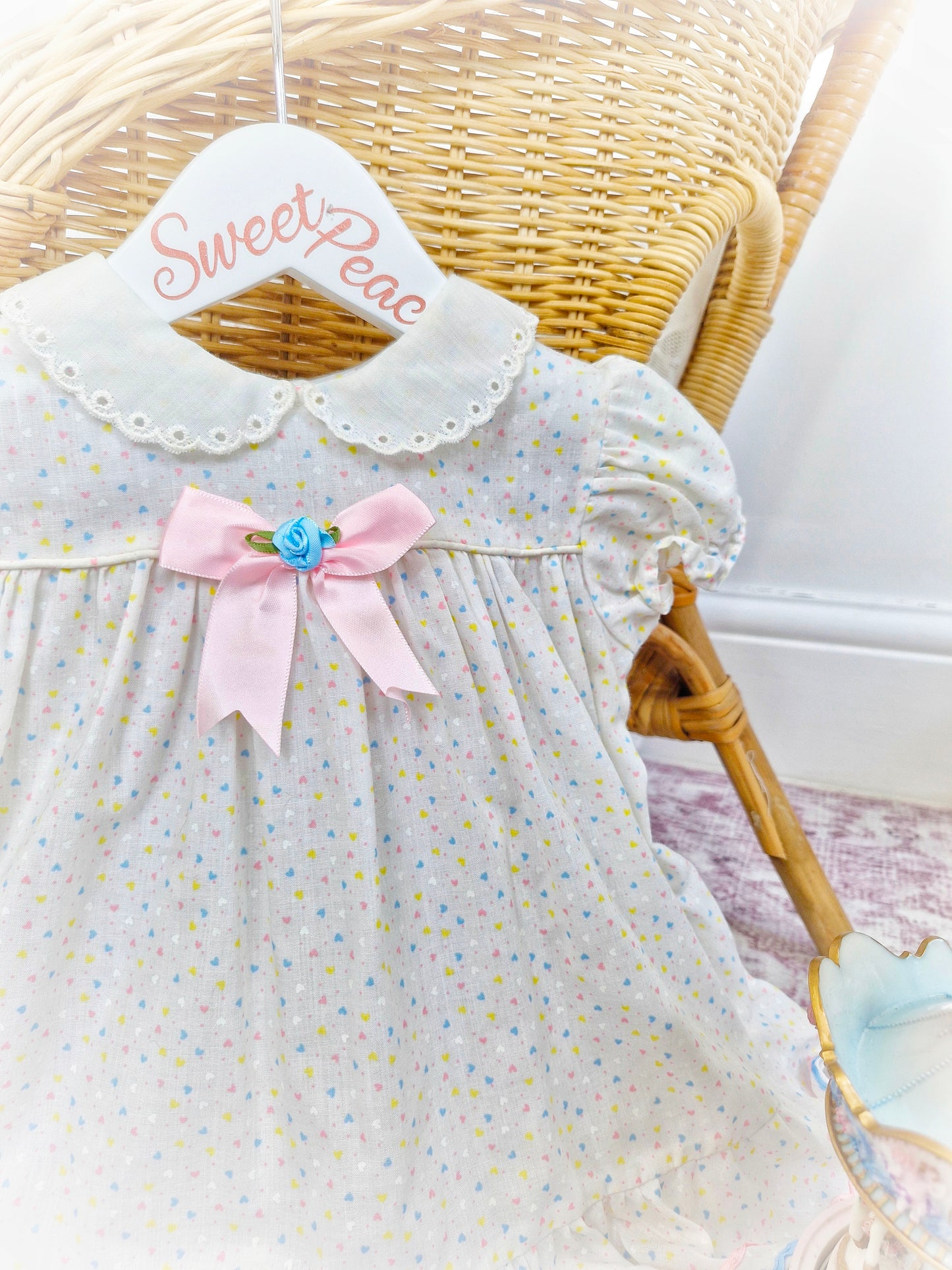 12-18 months. White collared dress with pastel hearts and ribbons from Lil' Airess