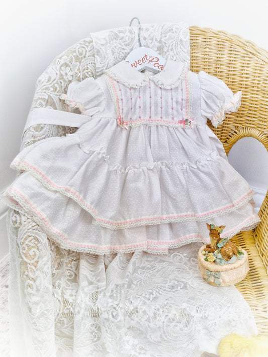 12 months. White Polly Flinders dress with pink smocking and ribbon details