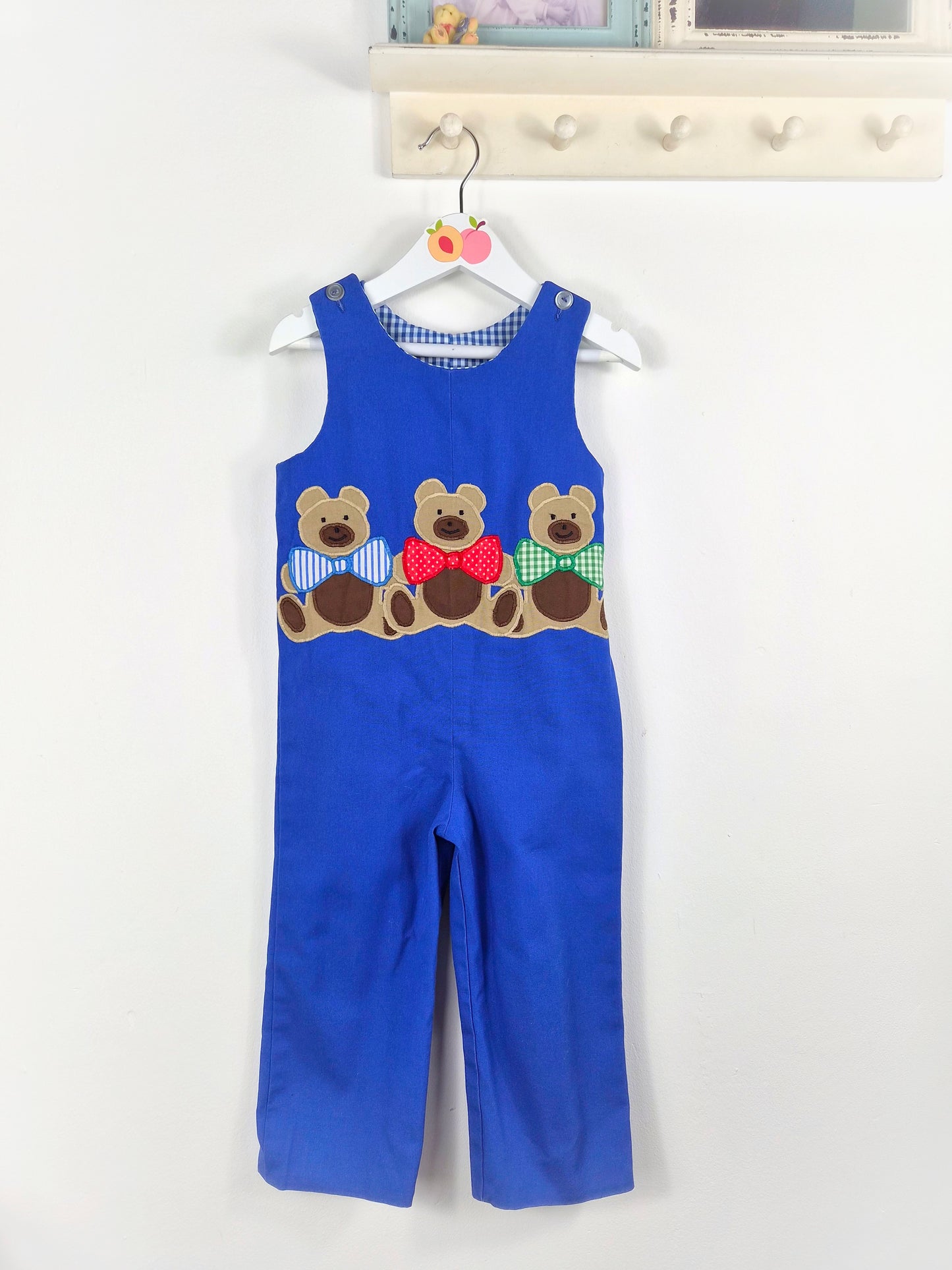 2-3 years.  Blue sleeveless vintage dungarees with 3 teddies wearing bow ties