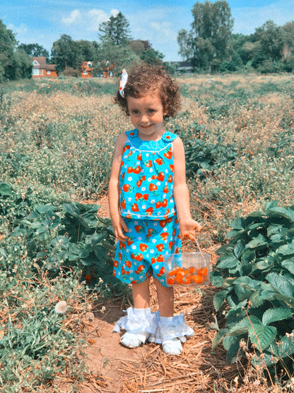 3 years. Two piece set, blue sleeveless top with matching shorts, strawberry print and dainty buttons