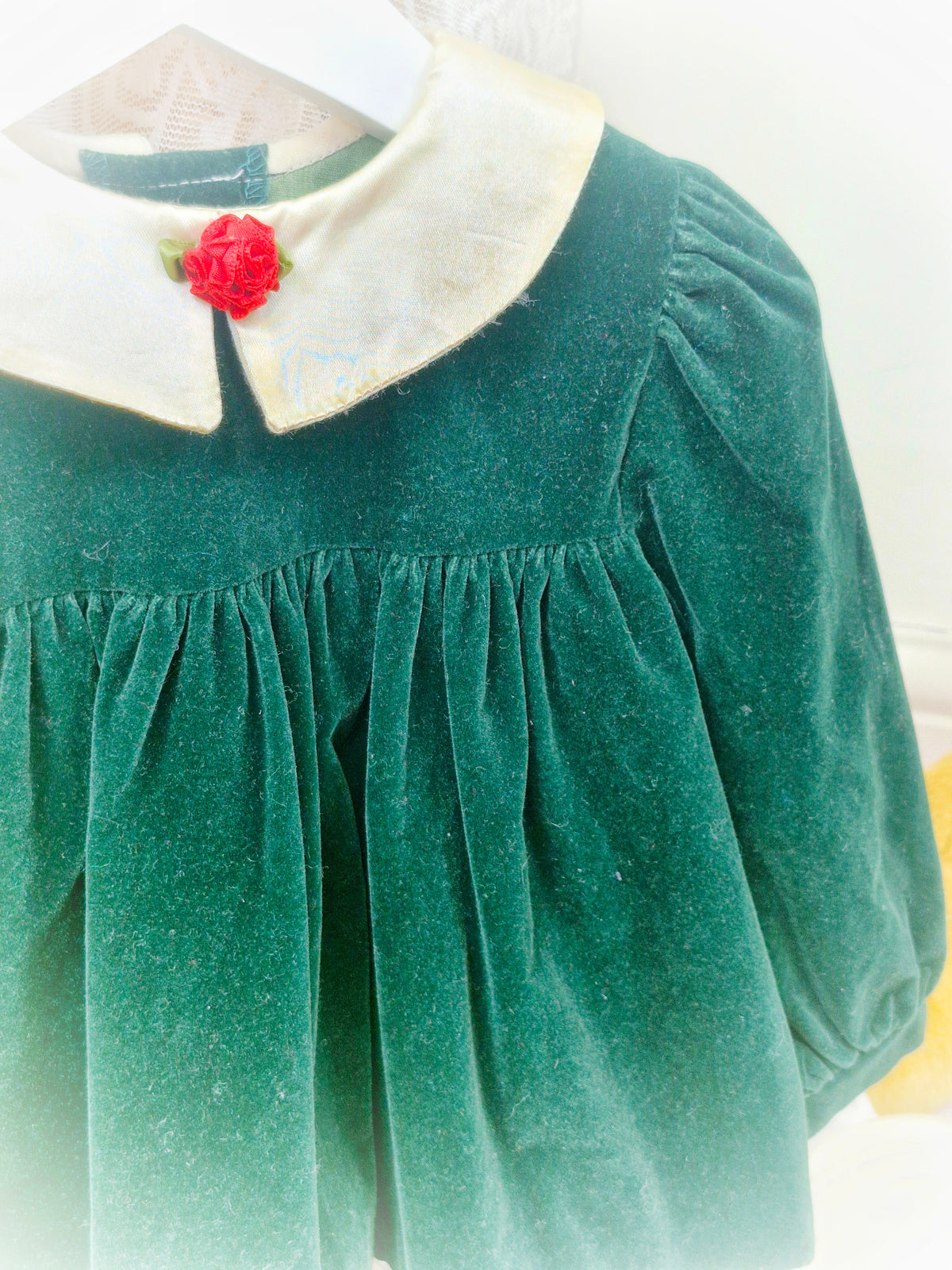 12-18 months. Vintage forest green velvet dress by Jolene, with cream satin collar, cream lace and red floral centre