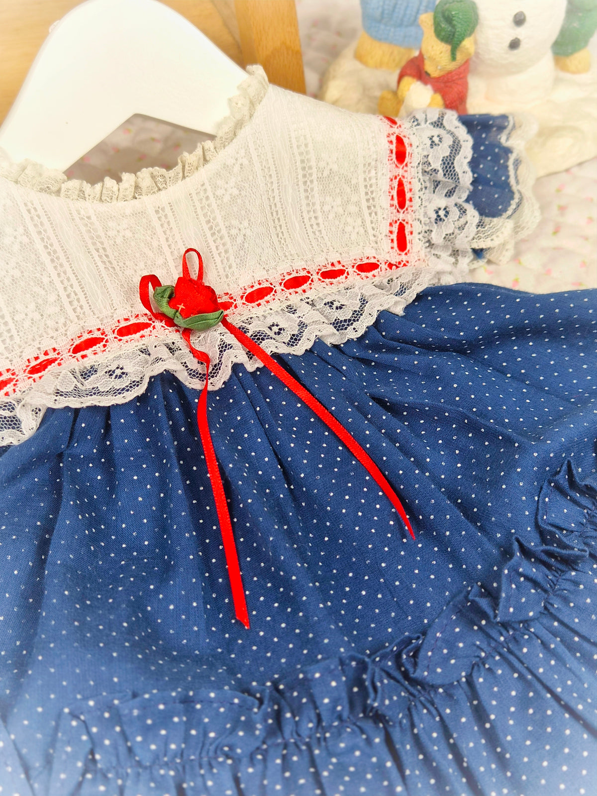 6-9 months. Navy blue polka dot vintage Bryan dress with white lace bib and red ribbon details