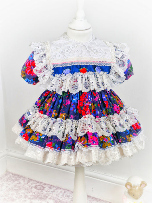 2-3 years. Kotton Kandi floral dress, navy with rosettes and lots of lace