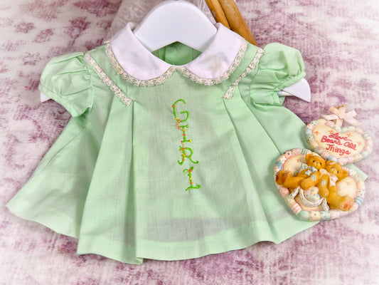 0-3 months. Mint vintage dress with puff sleeves, white collar and embroidered "Girl"