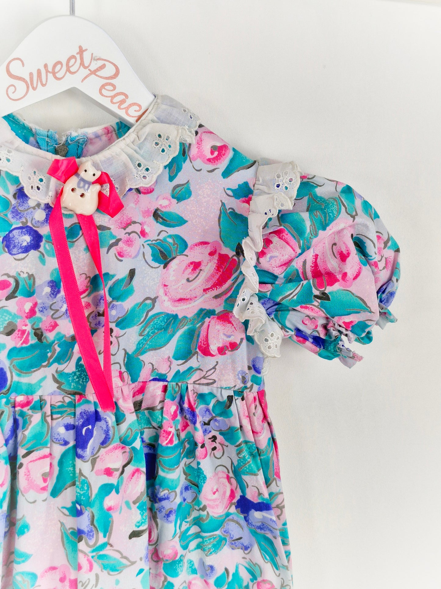 18-24 months. Floral romper with porcelain cat and pink ribbon