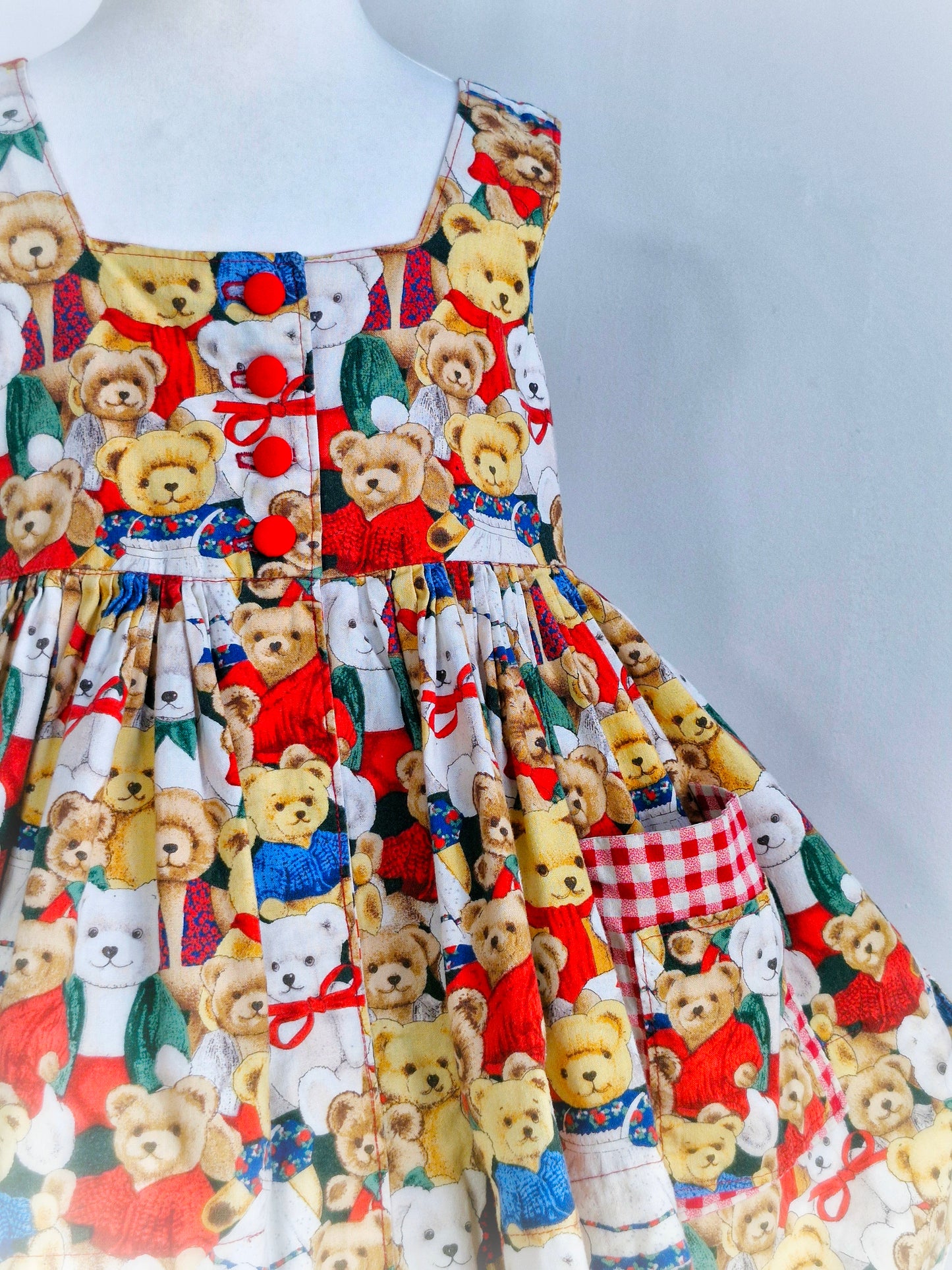 5 years. Handmade teddy print sleeveless dress with gingham details and red buttons