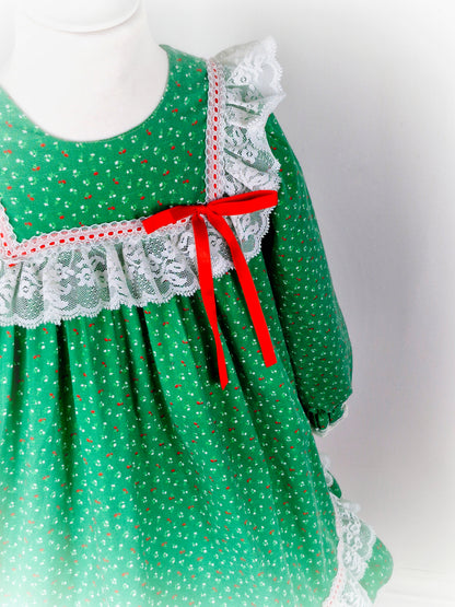6 years. Green vintage Bryan with red and white floral print, white lace details and red ribbon